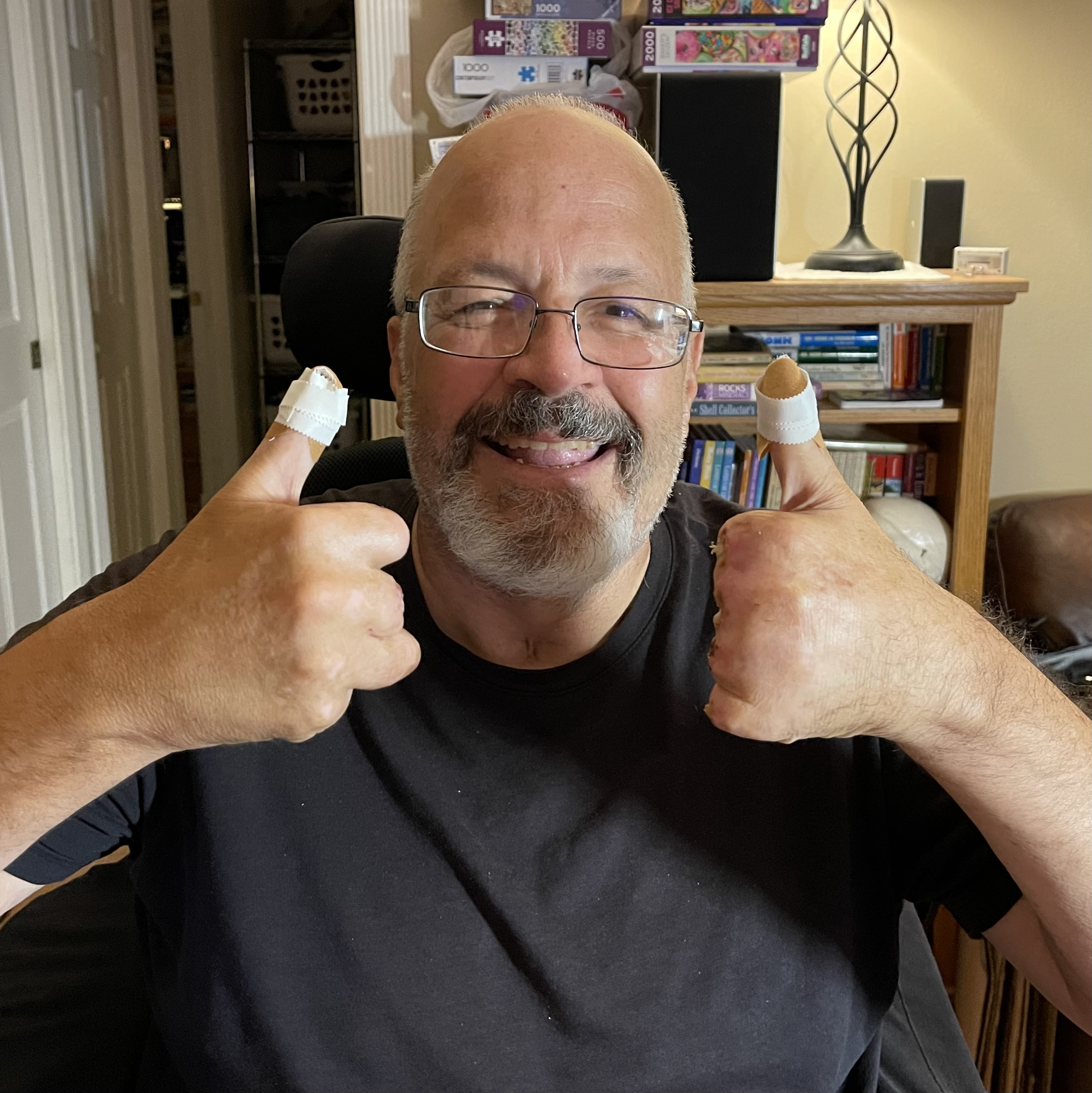James smiling and giving two thumbs up